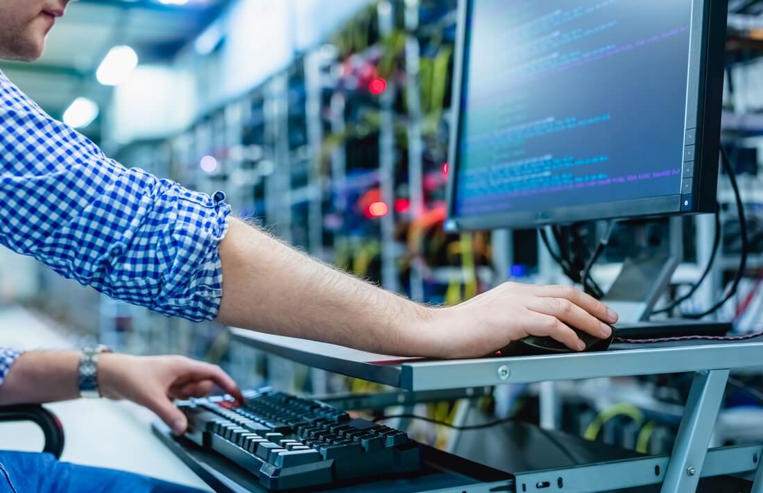 a focused programmer navigates lines of code, surrounded by a symphony of technology and innovation