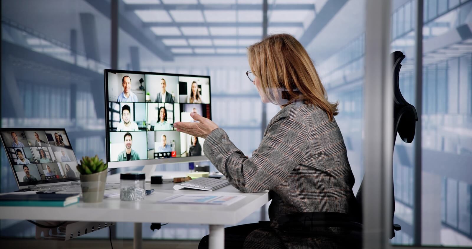 a professional engages in a virtual meeting with colleagues from various locations