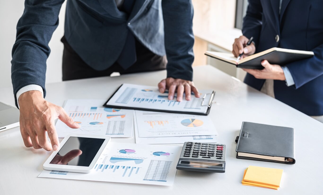 a team collaborates over data-driven strategies, analyzing charts and figures that guide their business decisions