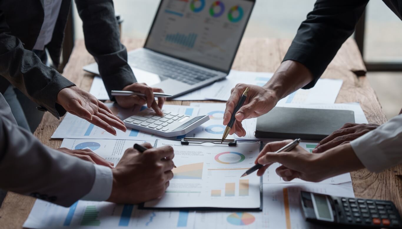 dynamic team of professionals collaborates over charts and graphs, analyzing data to drive business decisions