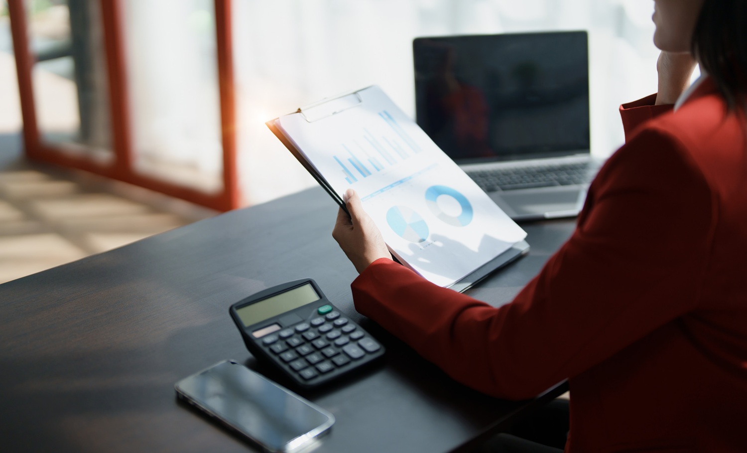 Young asian female work with financial papers at home count on calculator before paying taxes receipts online, planning budget glad to find chance for economy saving money, audit concepts