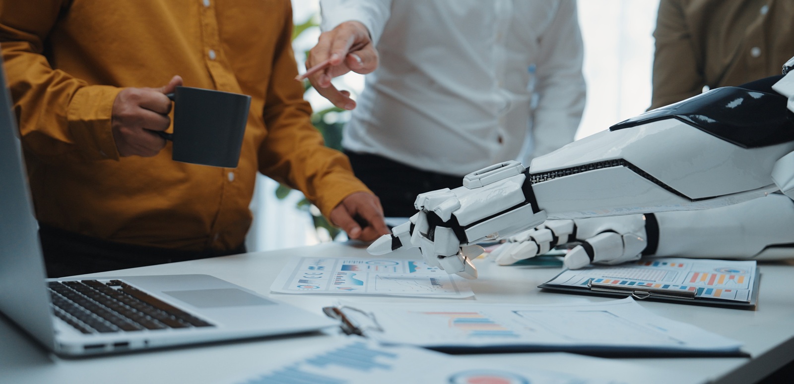 Professionals engage in a dynamic meeting with advanced robotic technology, exploring innovative ideas and enhancing collaboration in a modern office setting.Noogenesis