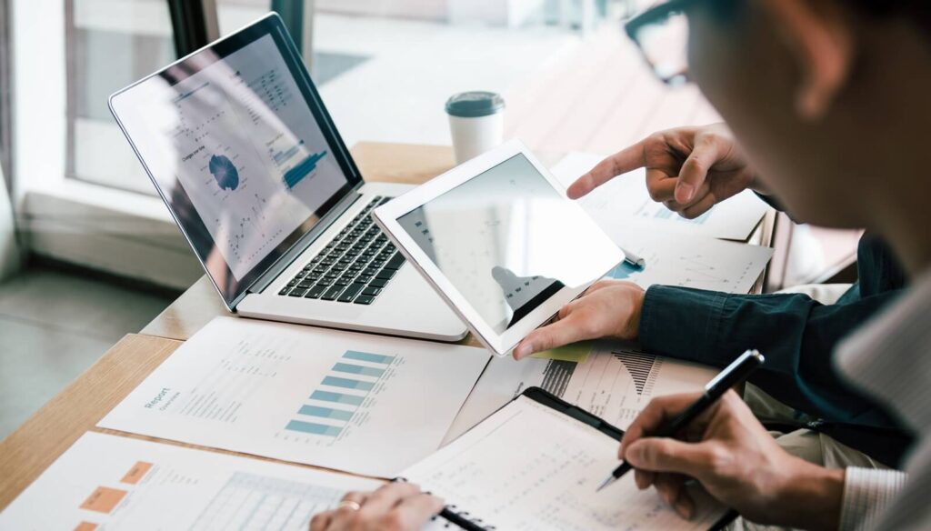 team collaborates on a project, engaged in a discussion while analyzing crucial data on digital devices Top Technology Challenges CPA Firms Face (and How We Solve Them)