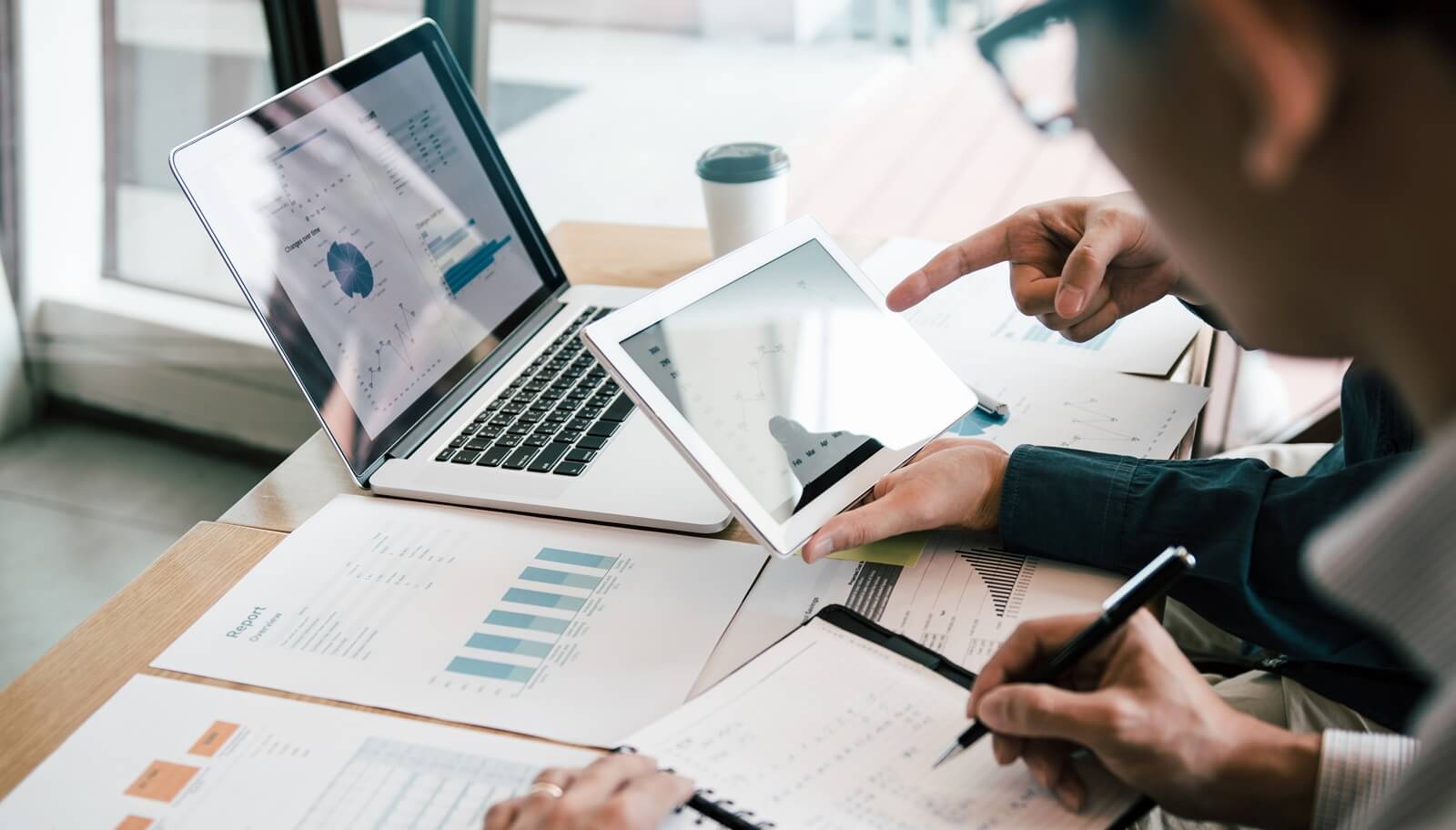 team collaborates on a project, engaged in a discussion while analyzing crucial data on digital devices Top Technology Challenges CPA Firms Face (and How We Solve Them)