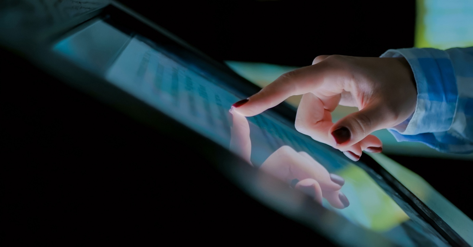 Woman using interactive touchscreen display at modern history museum