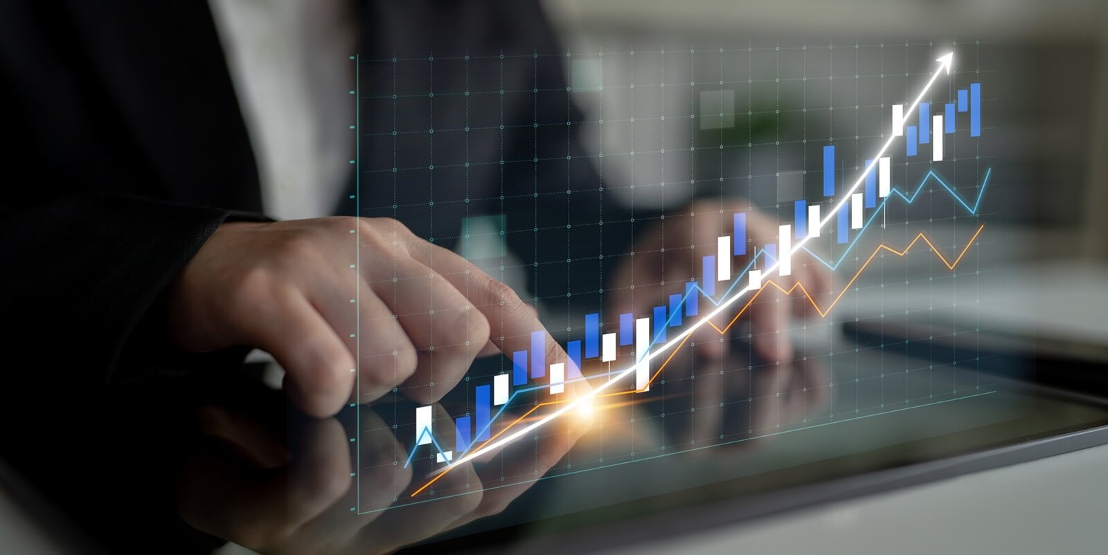 business professional engaged in analyzing financial data on a tablet, featuring an upward trend graph that symbolizes growth and market success in a modern office environment