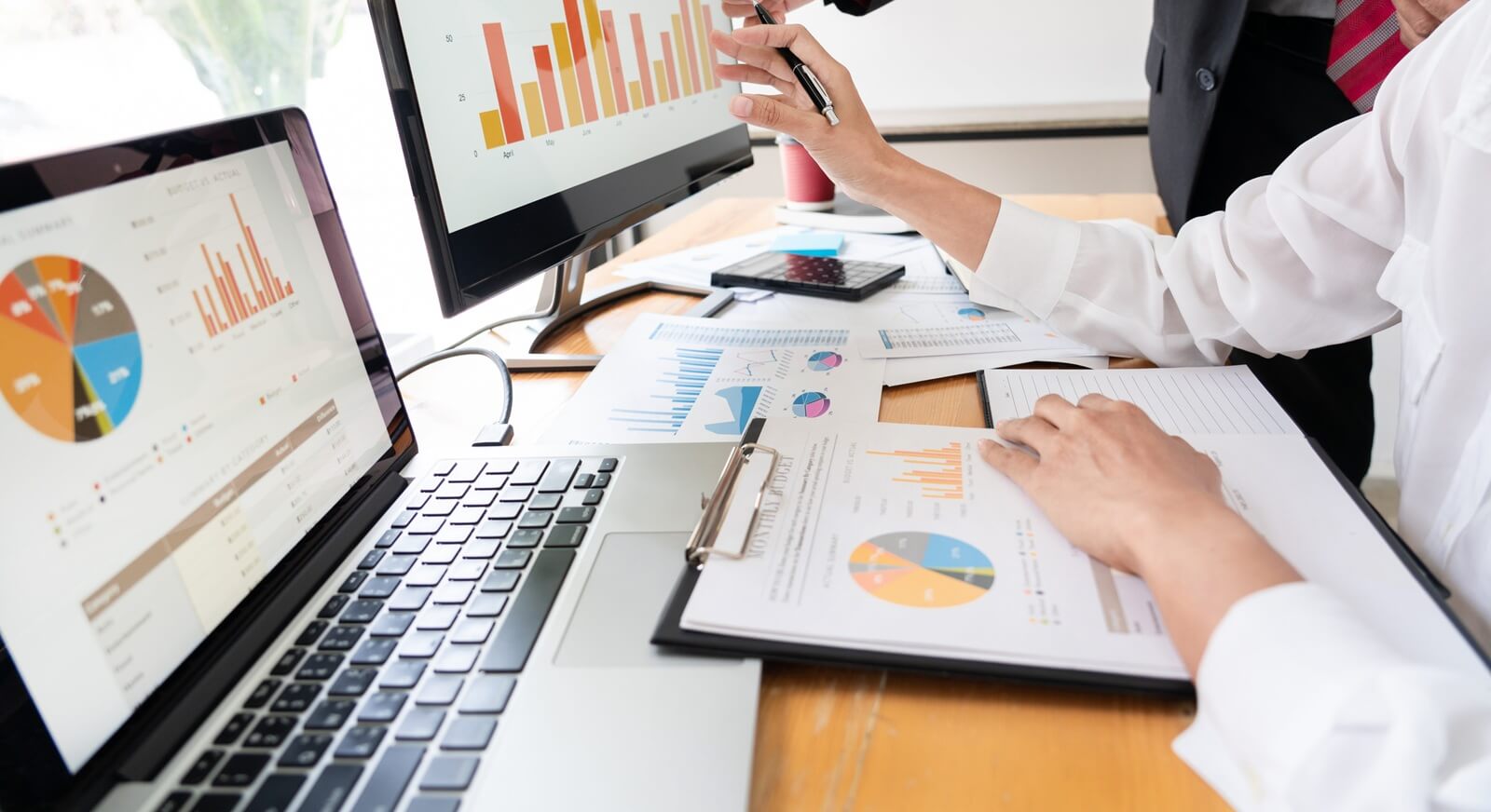 businessmen discussing project at meeting pointing explaining his idea charts and graph colleague at work having a meeting for project discussion