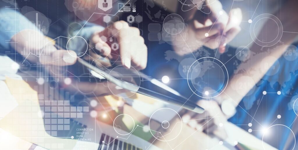 modern workspace, collaborators engage with technology, illustrating the seamless integration of digital tools in problem-solving and innovation