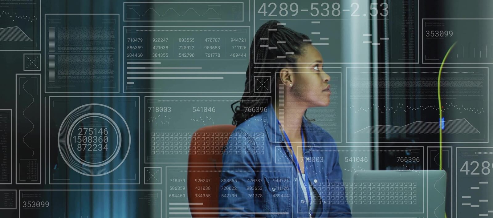 technician wearing shirt and badge, plugging cables and typing on laptop in server room