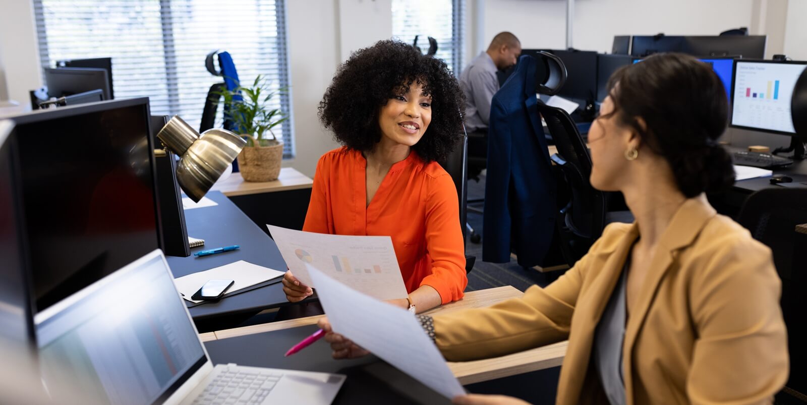 two professionals engage in a lively discussion, sharing insights and ideas as they review essential documents