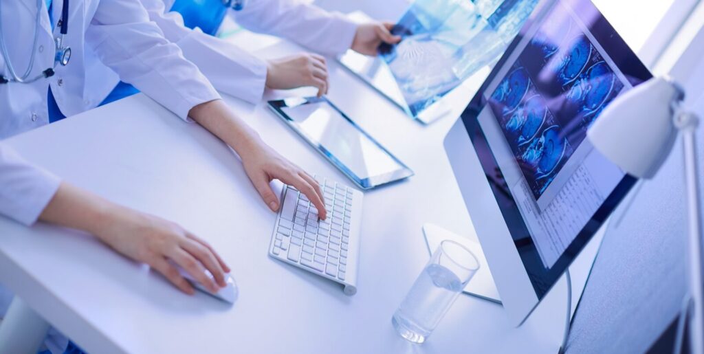two young female doctors working on computer at hospital