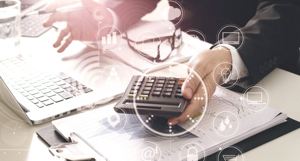 businessman hand working with finances about cost and calculator and latop with mobile phone on withe desk in modern office