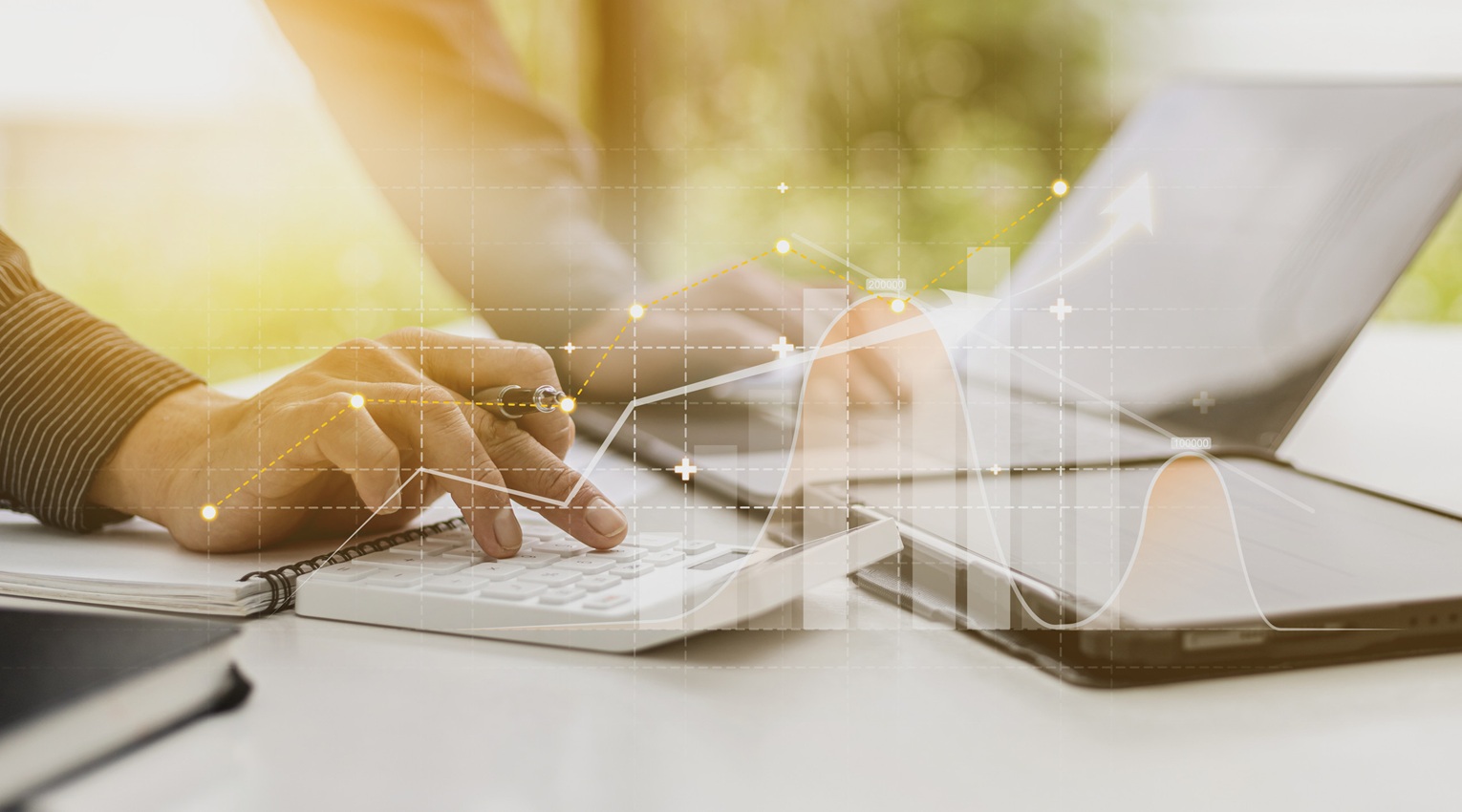person pressing calculator to check financial information from documents