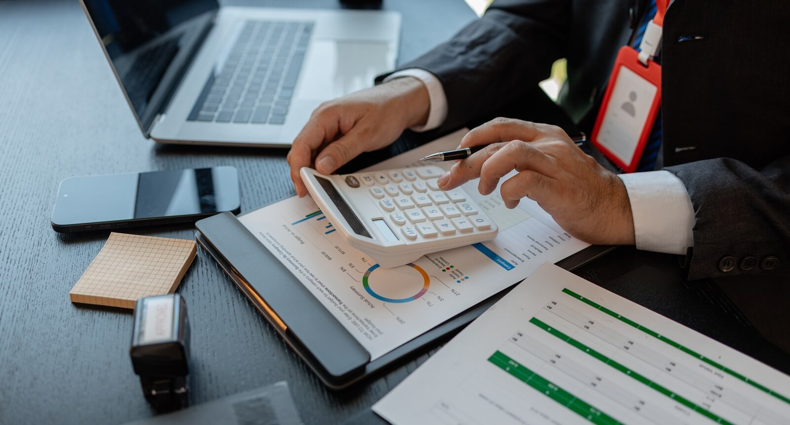 a businessman reviews the company's financial documents in his office, the accountant is rushing to check the figures