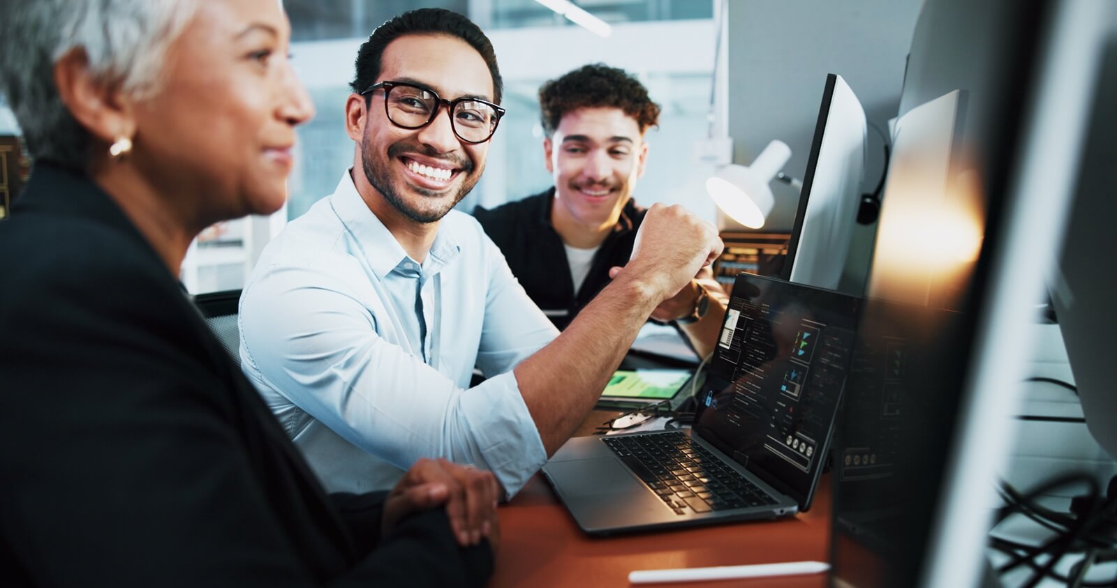 teamwork and business people with laptop for coding, programming and conversation at night