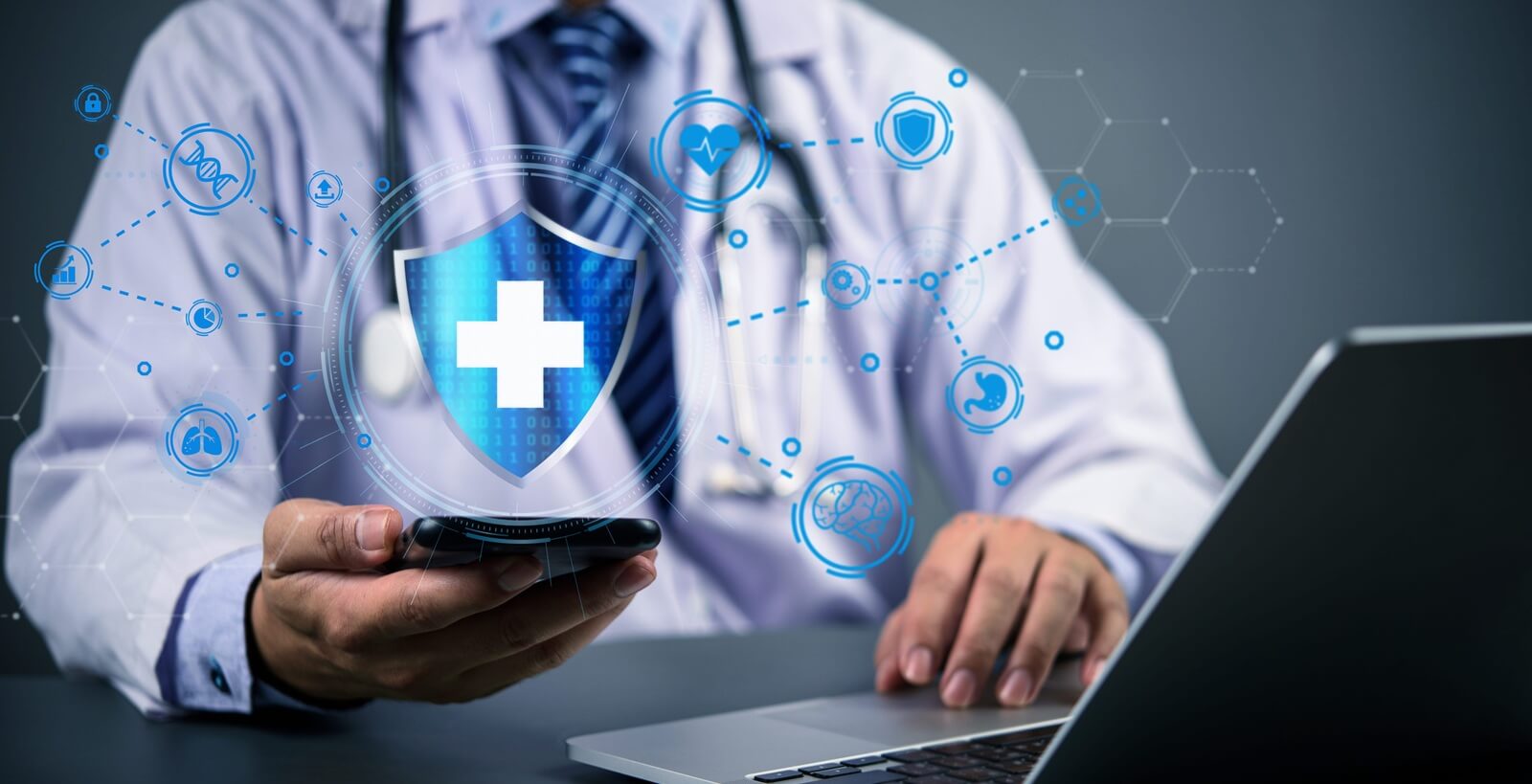 doctor using smartphone and laptop with digital medical icons and shield symbol