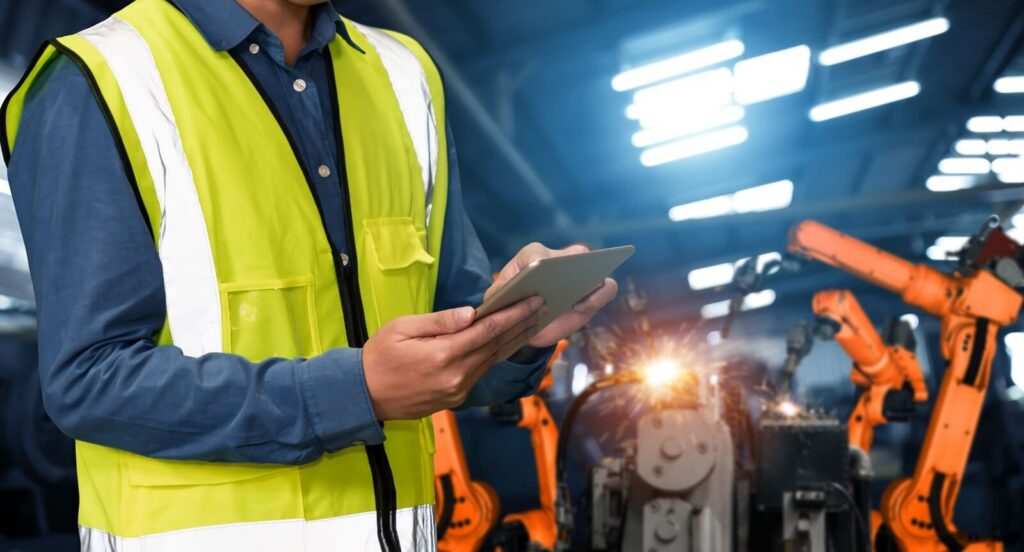 engineer use advanced robotic software to control industry robot arm in factory