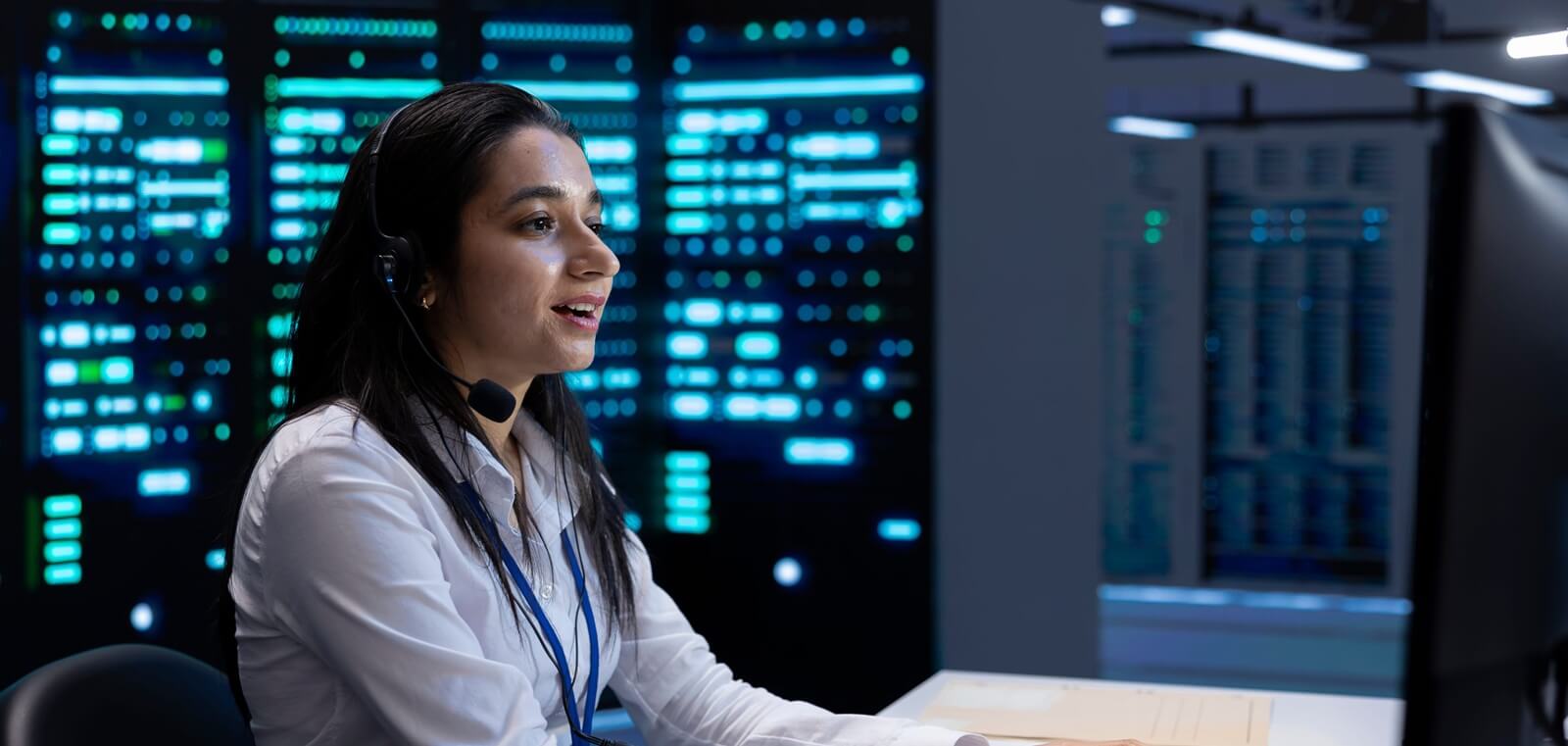 smiling engineer in data center providing support for companies, troubleshooting malfunctions