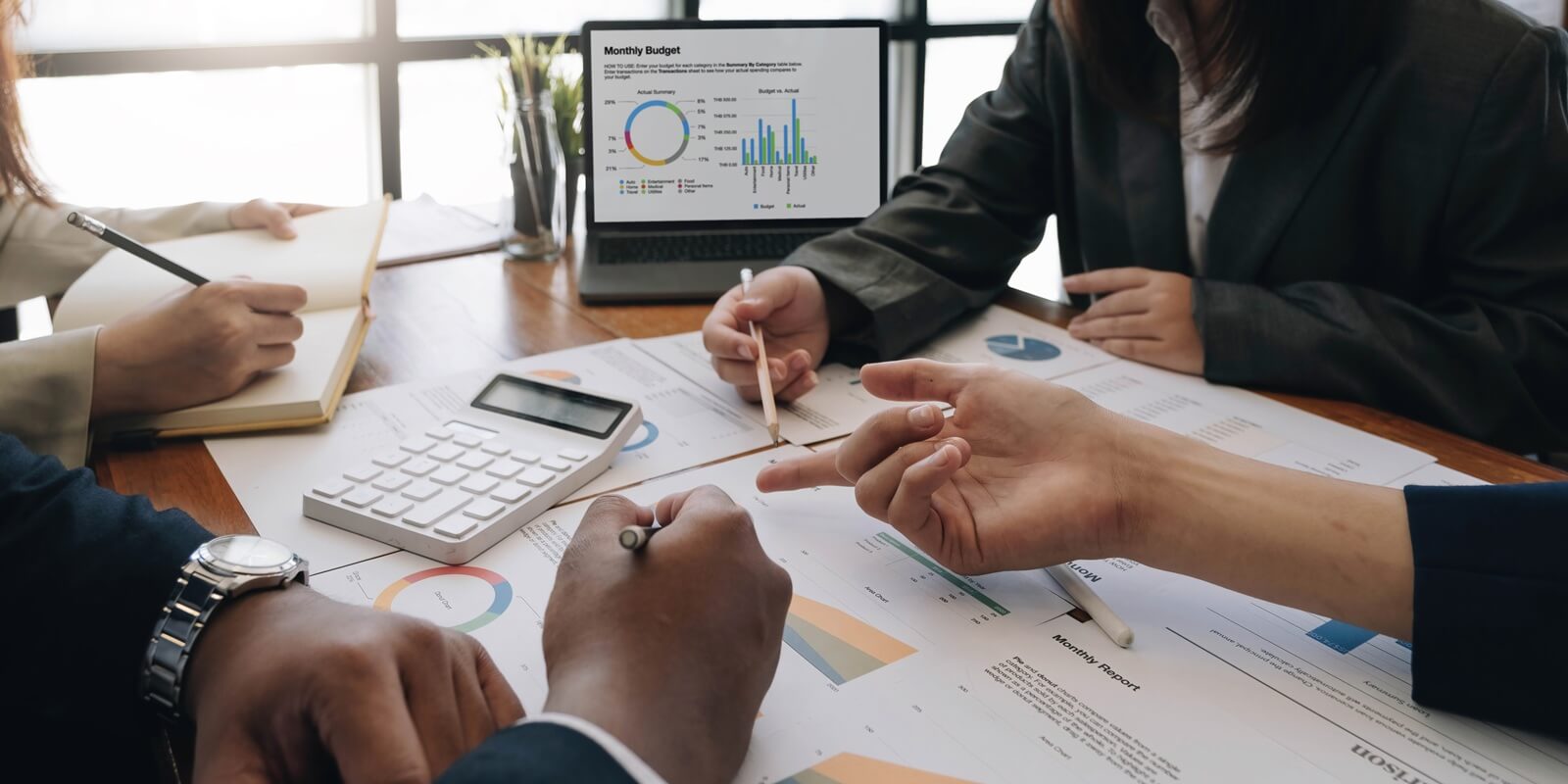 team analyzing income charts and graphs with modern laptop computer