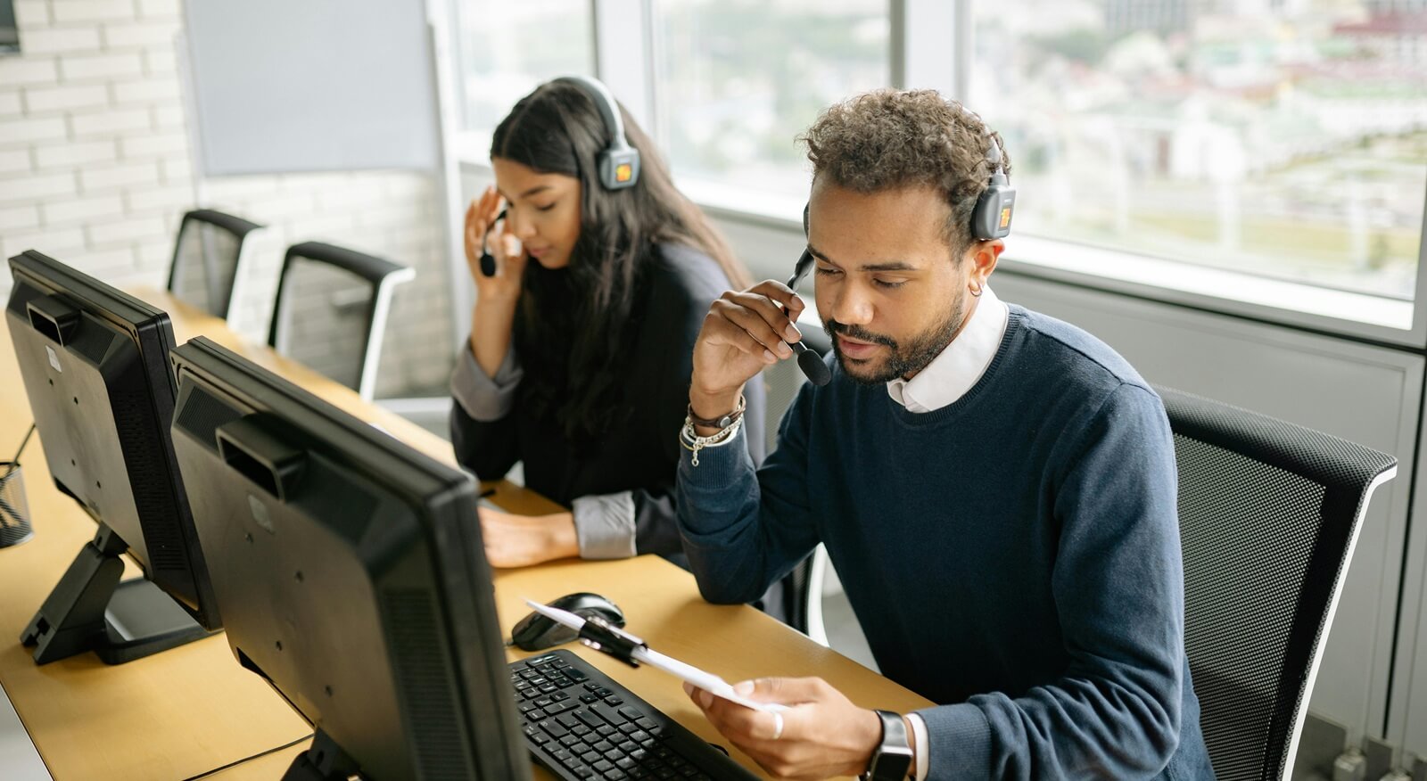 a man and woman working in the call center together