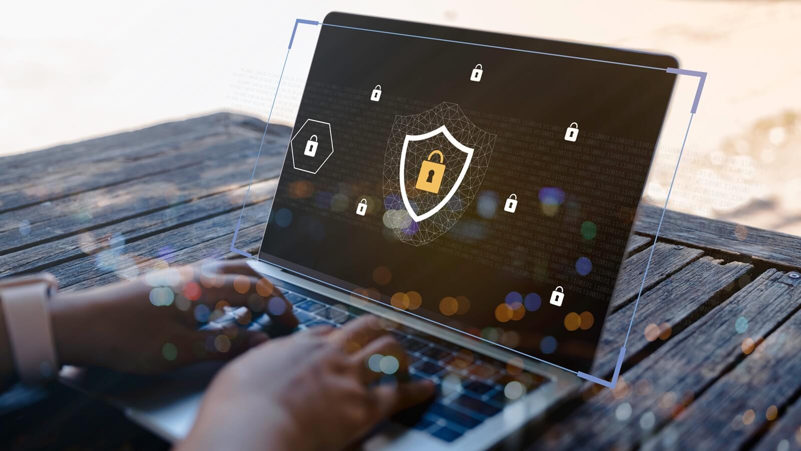 businesswoman hand using laptop with data protection