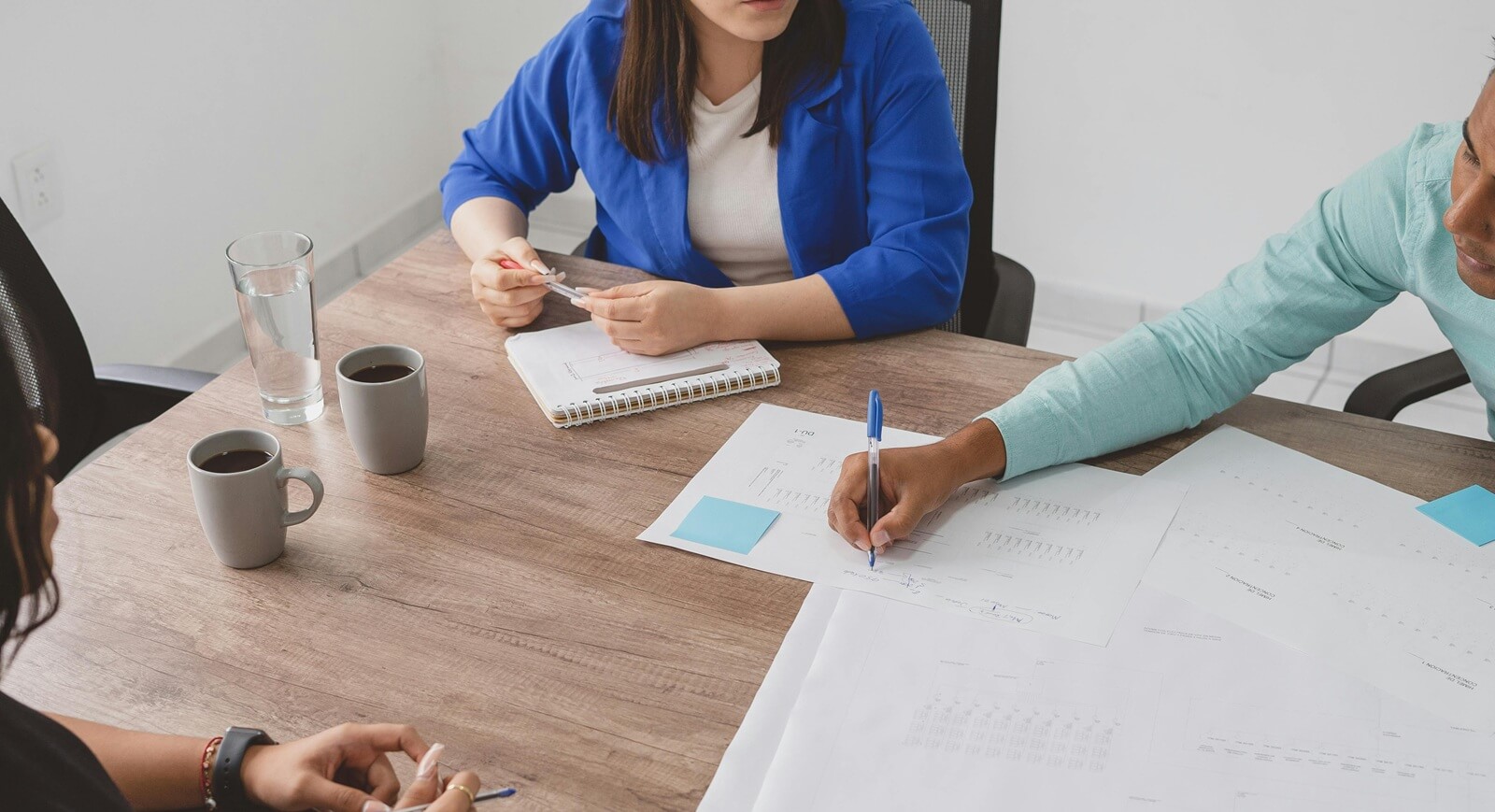 group of business people working together on a plan chart