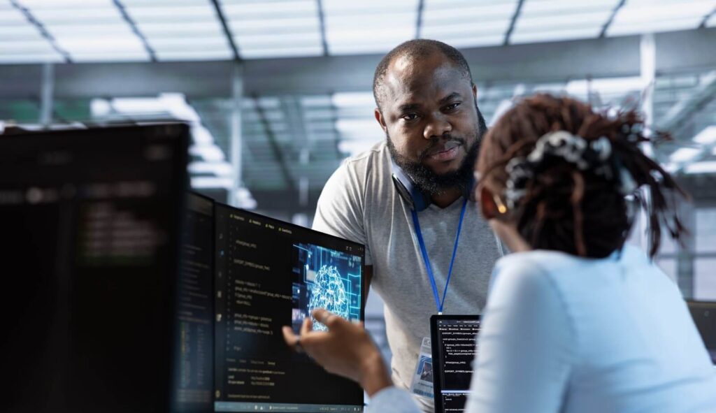 system administrator working with colleague in data center facility providing computing resources for different workloads