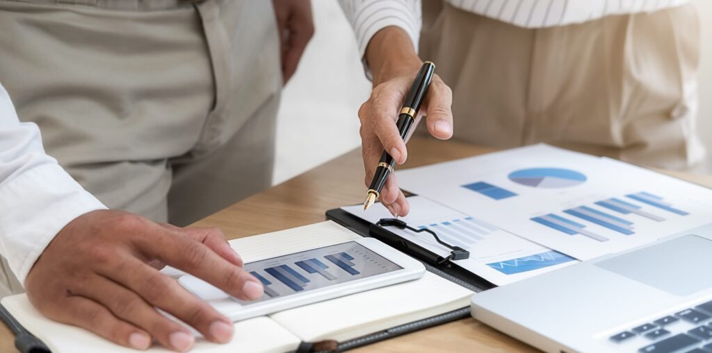 Business team brainstorming and discussing with financial data and report graph
