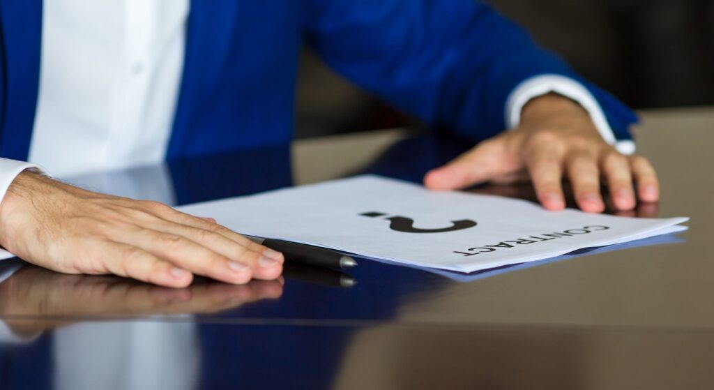 close up of businessman thinking on a contract paper