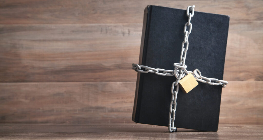 mysterious black journal bound in chains symbolizes the secrets it holds, locked away from the outside world