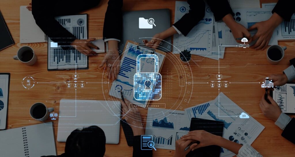 business meeting centered on data security features professionals analyzing charts on various devices