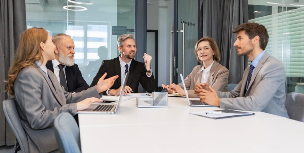 business meeting - manager discussing work with his colleagues - executive guide to CMMC