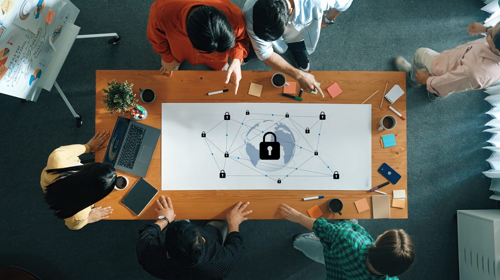 diverse team collaborates in an office space, discussing cybersecurity strategies
