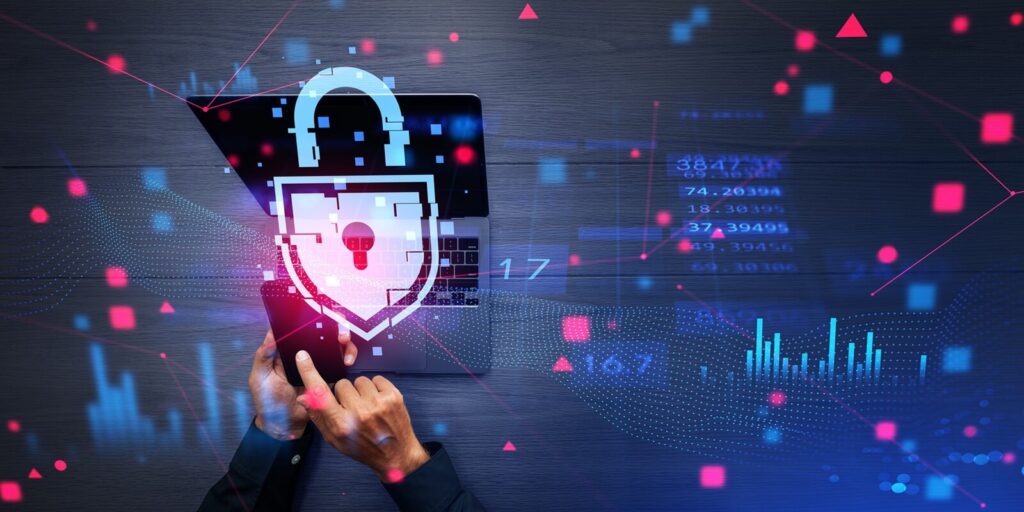 view of businessman holding smartphone and laptop with double exposure of immersive cybersecurity interface lock