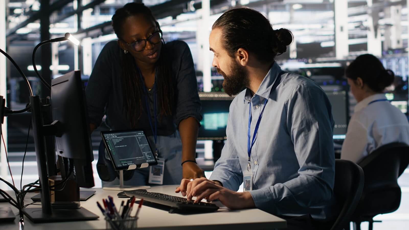 Teamworking system administrators in data center integrating AI automation during maintenance session (1)