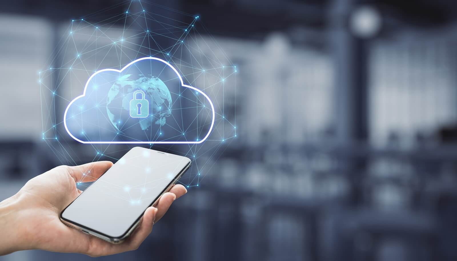 businessman hand holding smartphone with abstract glowing cloud hologram with globe and safety icons