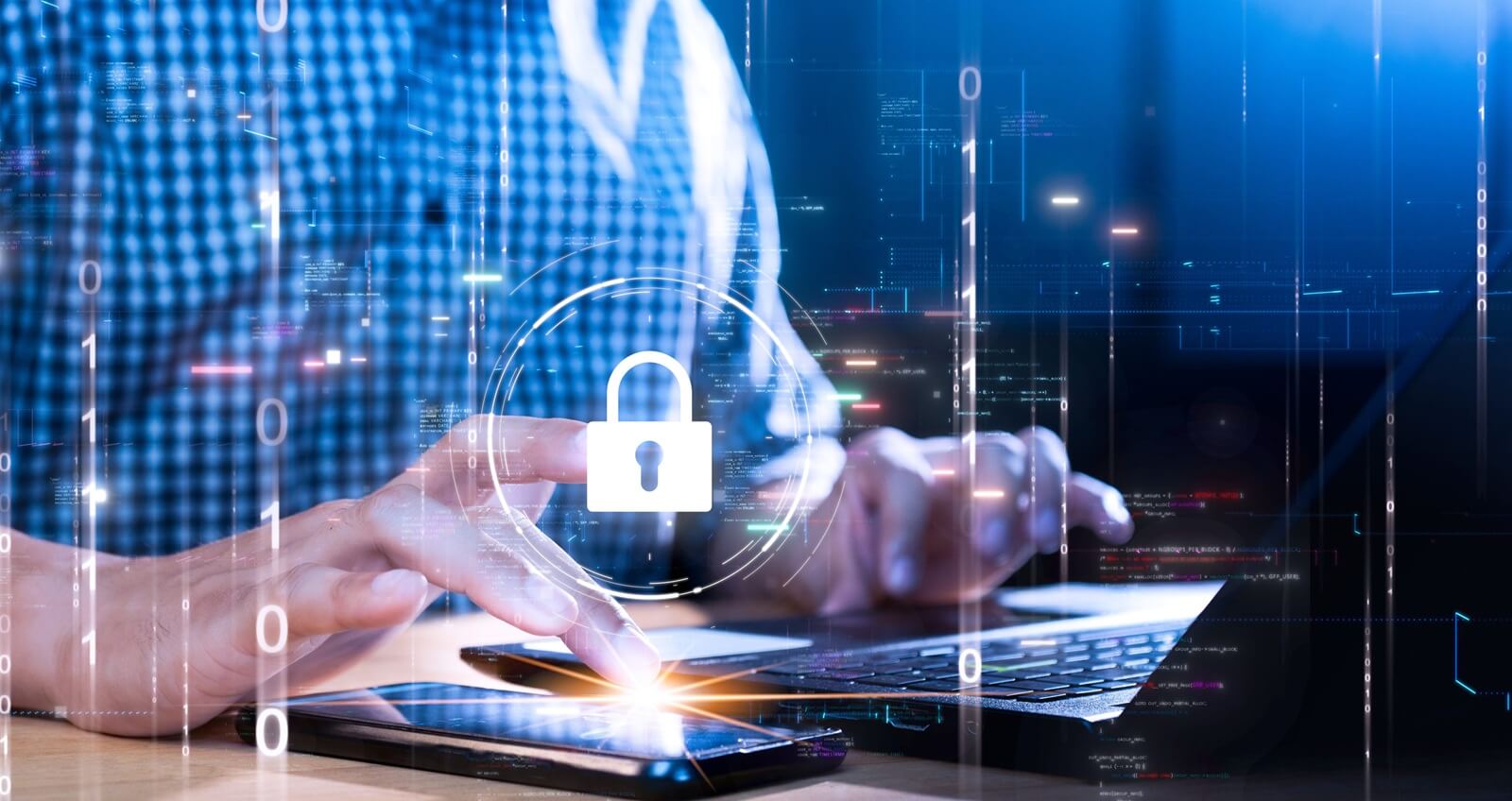 person using laptop and smartphone with digital key icon symbolizing data security