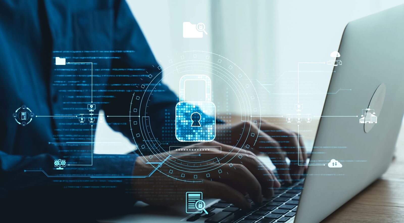 conceptual image of hands typing on a laptop with graphical security elements surrounding