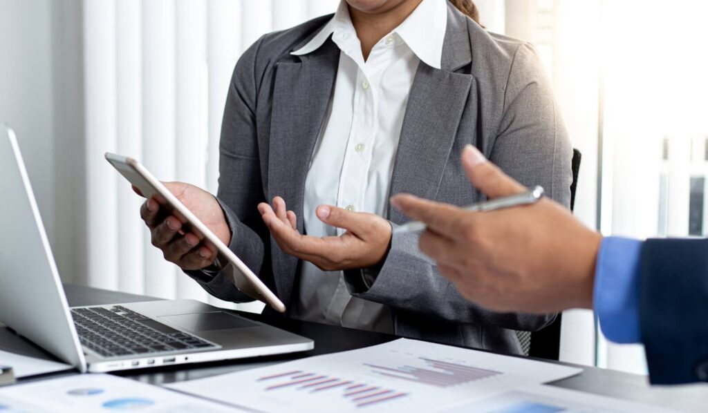 financial accountants are discussing and analyzing charts to plan strategies to meet customer needs