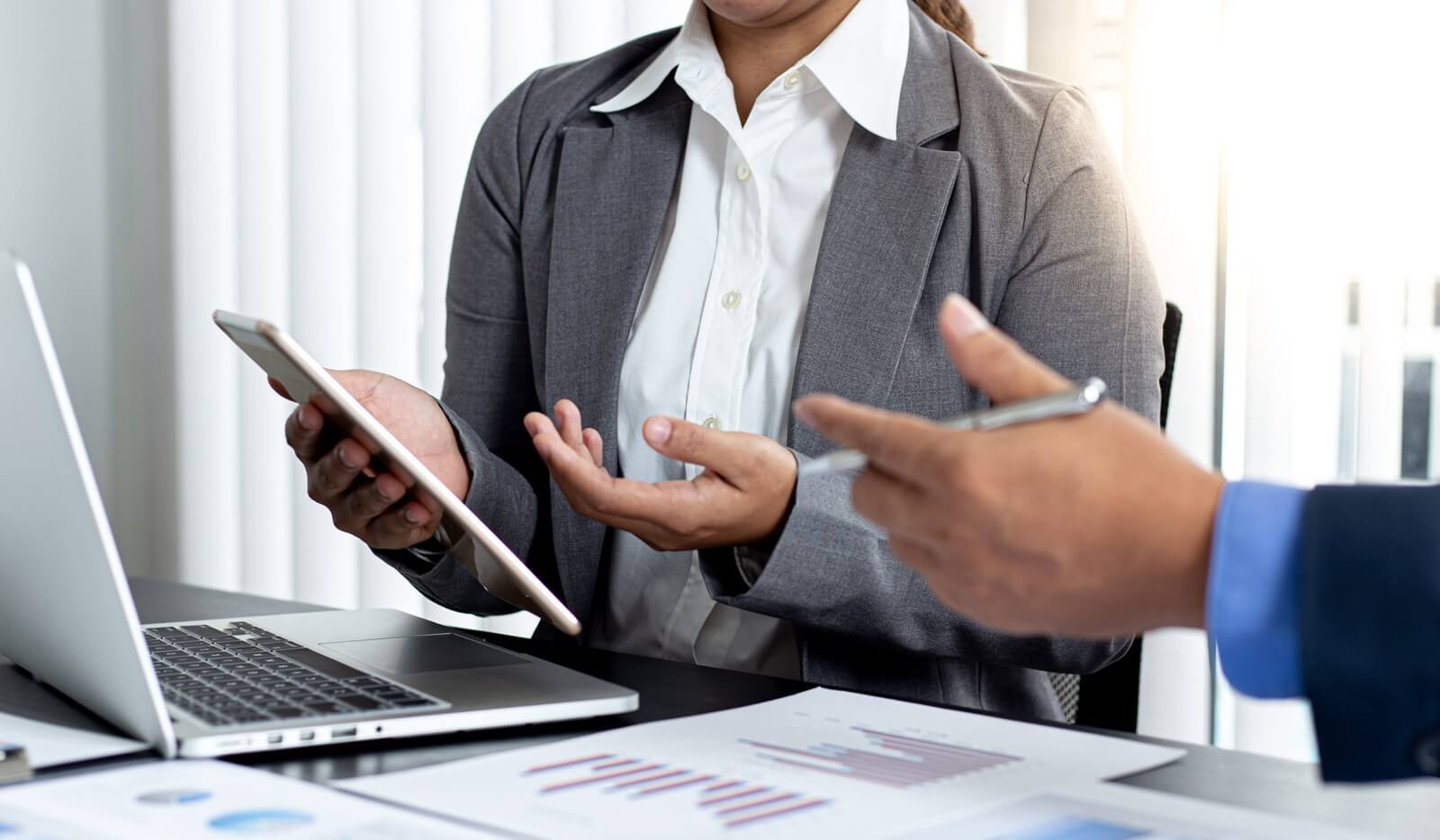 financial accountants are discussing and analyzing charts to plan strategies to meet customer needs